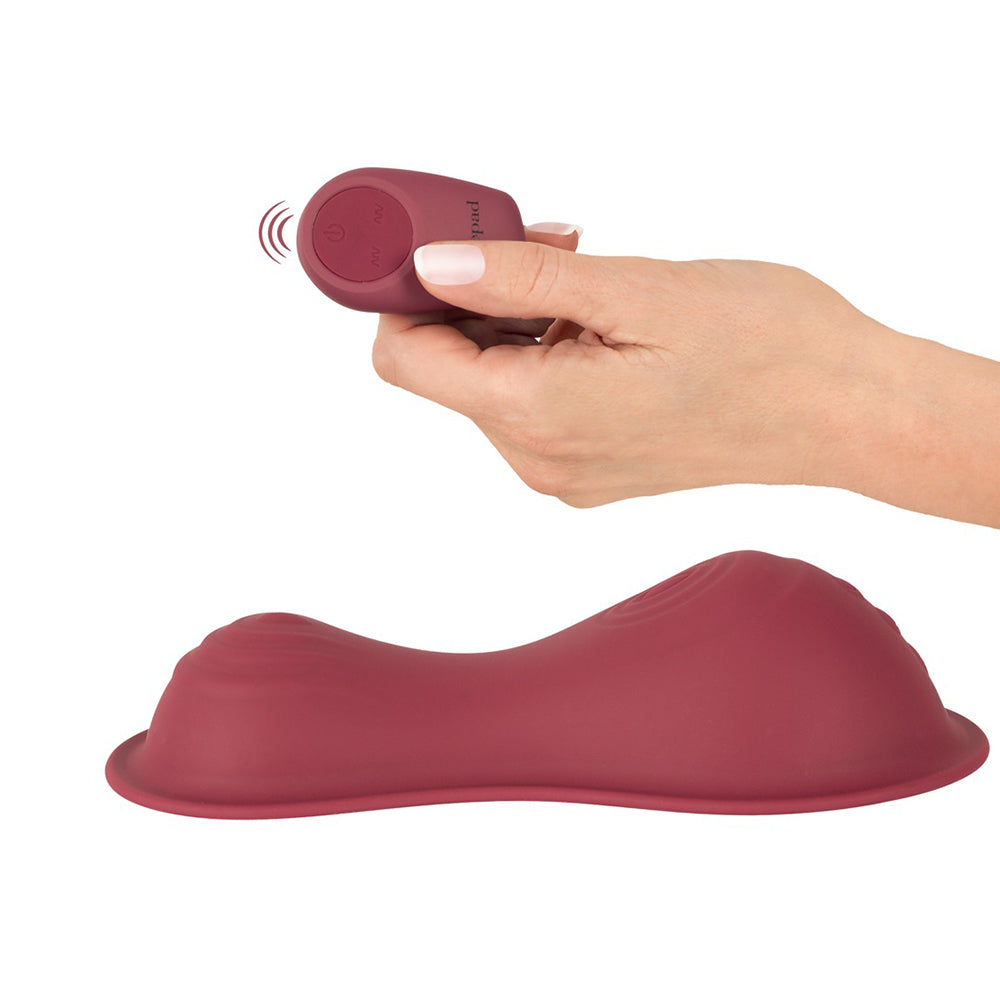 Vibepad Intense 2 Grinding Pad Vibrator with Remote and wireless controller in hand.