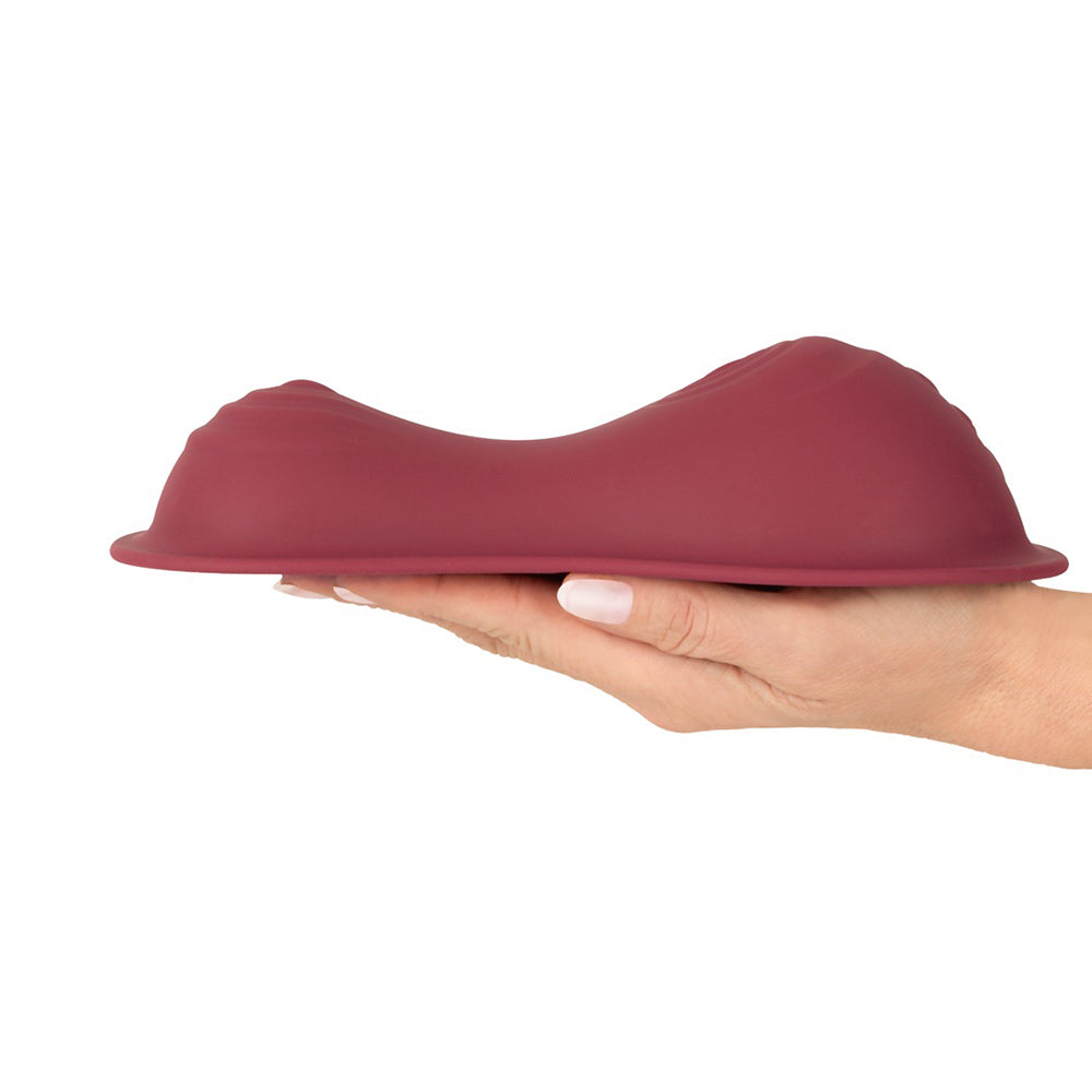 Vibepad Intense 2 Grinding Pad Vibrator with Remote displayed in hand, showcasing its ergonomic design for pleasure.