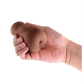 A hand holding the Pocket Pals Anal Stroker Brown, showcasing its compact design and realistic texture.