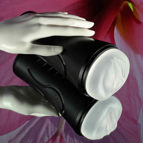 Zero Tolerance Hold Tight Vibrating Stroker Black with a hand demonstrating its squeezable design.