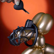 UPKO Caged Beast male chastity device kit displayed on a balloon figure with a black heart-shaped key, showcasing sleek design.