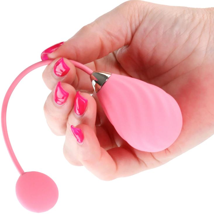 Techno Kandi App Compatible Silicone Egg Vibrator Pink held in hand, showcasing its sleek design and premium silicone material.