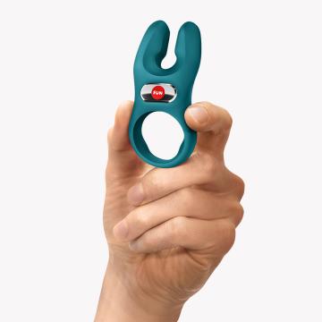 Fun Factory NOS Vibrating Cock Ring Green held in hand, showcasing its design and comfort features.