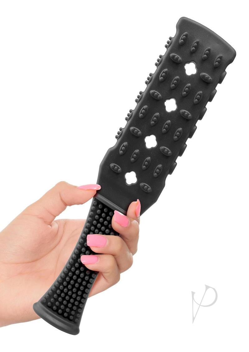 Fetish Fantasy Series Rubber Paddle 10.5 inch Black in hand, showcasing its unique design for impact play.