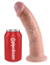 King Cock 9 Inch Realistic Dildo Suction Cup Flesh next to a soda can for size comparison.