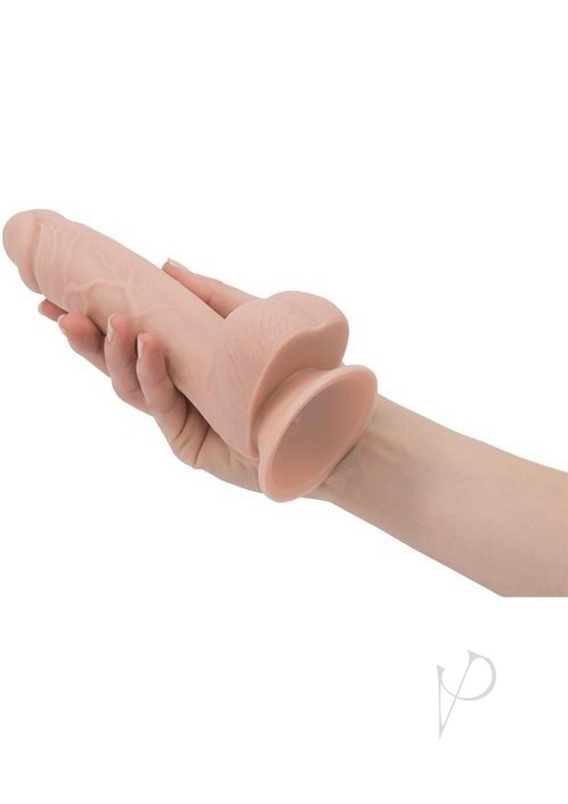 Addiction Mark 7.5 Inch Silicone Dildo with Balls Vanilla held in hand, showcasing its lifelike design and features.