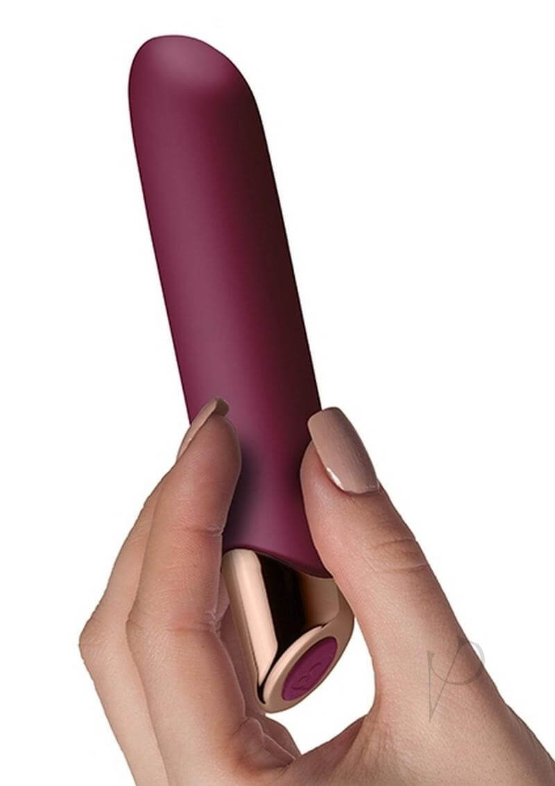 Chaiamo Rechargeable Silicone Vibrator Burgundy held in hand showcasing its elegant design and soft texture.