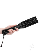 Ouch Luxury Diamond Pattern Vinyl Paddle Black held in a hand, showcasing its elegant diamond pattern design.