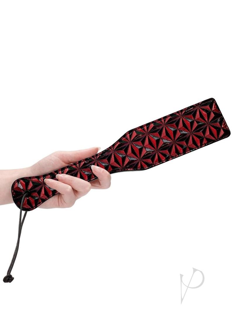 Ouch Luxury Diamond Pattern Paddle Burgundy held by a hand, showcasing its diamond pattern and stylish design.