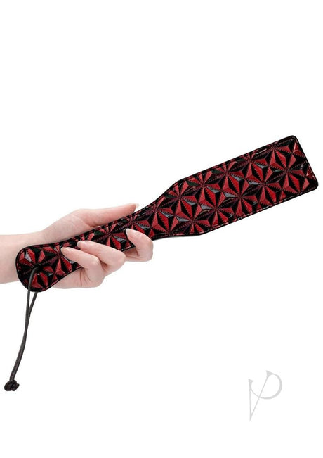 Ouch Luxury Diamond Pattern Paddle Burgundy held by a hand, showcasing its diamond pattern and stylish design.