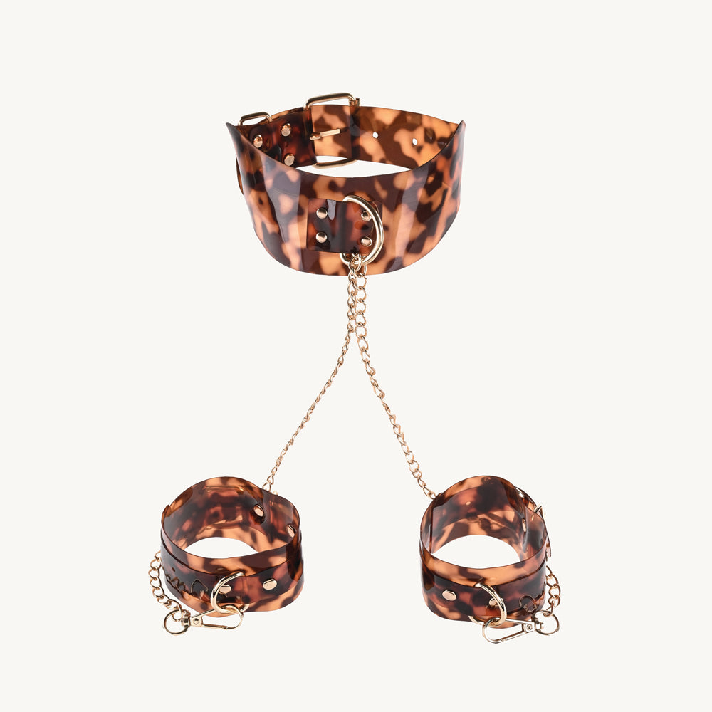 Sincerely Amber Neck and Wrist Restraint featuring leopard print with gold-plated chains for stylish submission.