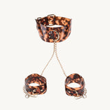 Sincerely Amber Neck and Wrist Restraint featuring leopard print with gold-plated chains for stylish submission.