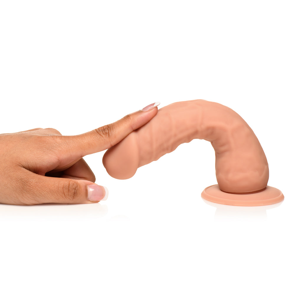 Hand gently touching Easy Riders 7 Inch Silicone Dildo Medium for lifelike stimulation and authenticity.