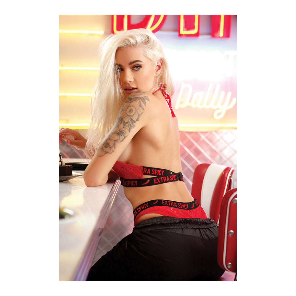 Fantasy Lingerie Extra Spicy Halter Bralette Panty Set Red worn by model at a diner, showcasing the stretch-lace design and styling.