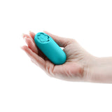 Sugar Pop Harmony Rechargeable Mini Vibrator Teal held in a hand, compact and discreet for travel.
