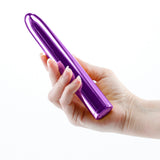 A person holding the Chroma 7 inch Rechargeable Vibe Purple, showcasing its sleek design and vibrant color.
