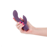 NS Novelties Obsession Juliet Rabbit Vibrator Dark Purple held in hand, showcasing its sleek design and flexible form.