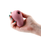 Desire Tresor Dawn Air Pulse Clitoral Stimulator held in a hand, showcasing its ergonomic design and gentle air pulse feature.