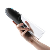 Hand holding the Enlarge Colossus Rechargeable Penis Pump Black showcasing its sleek design and transparent cylinder.