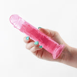 Fantasia Upper 6.5 inch Realistic Dildo Pink held in hand, showcasing its lifelike design and vibrant color.