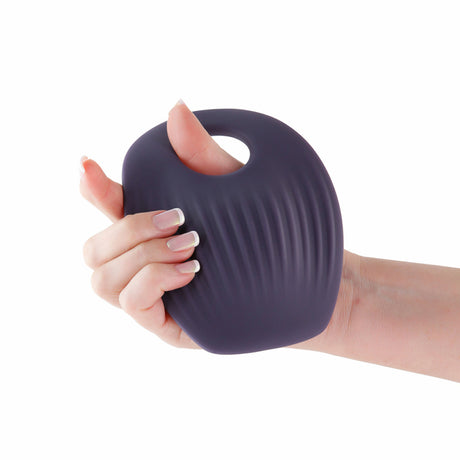 Inya Grinder Gray App Controlled Grinding Pad Vibrator held in hand, showcasing ergonomic design and textured surface.