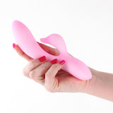 Image of NS Novelties Pure Dawn Rabbit Vibrator Pink held in a hand with manicured nails.