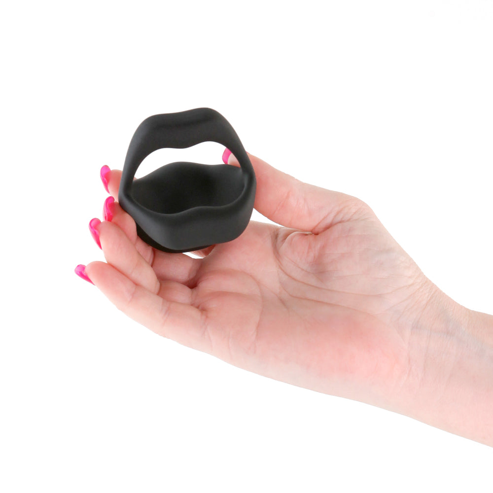 Techno Strobe App Compatible Cock Ring Black held in a hand, showcasing its sleek design and silicone material.