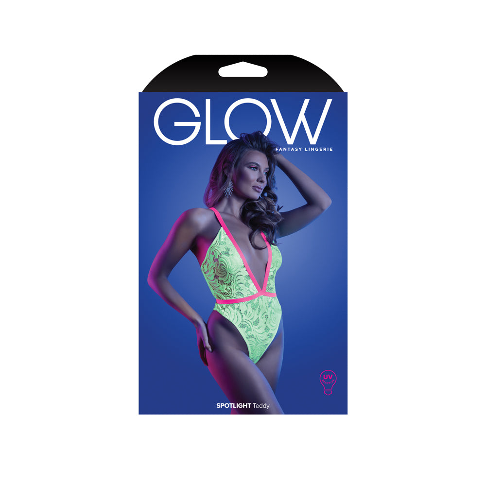 Fantasy Lingerie Spotlight Teddy Neon Green M L packaging featuring a model in a UV-reactive lace teddy under blacklight.