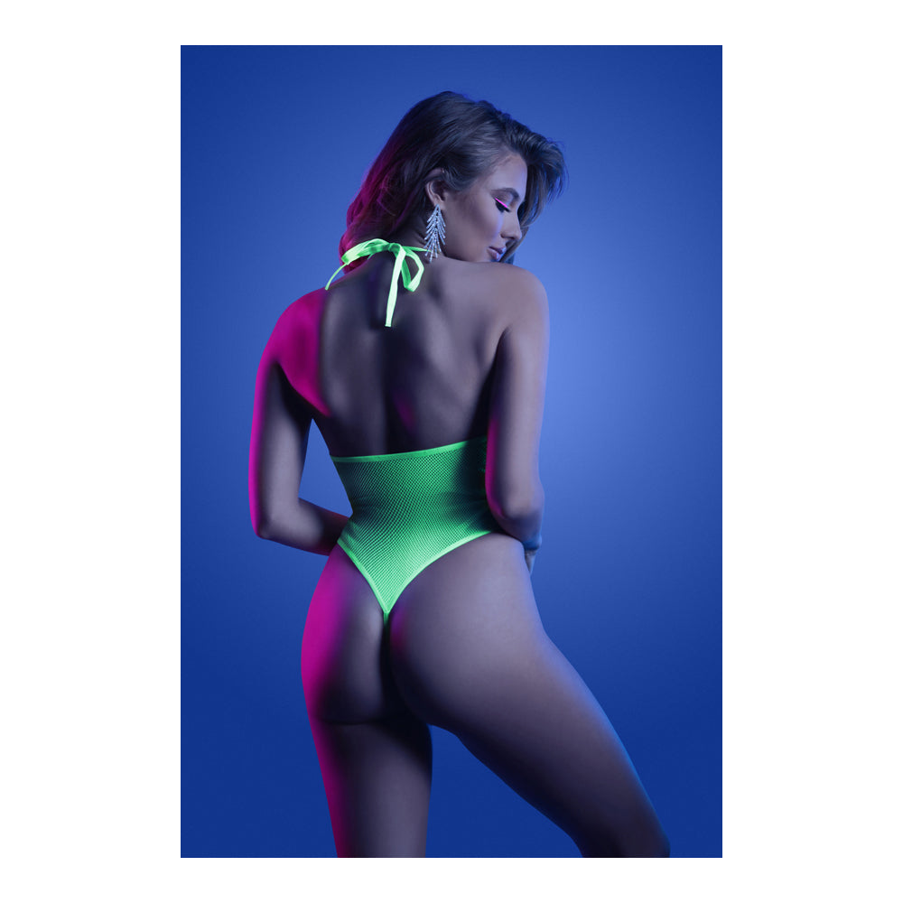 Fantasy Lingerie Nocturnal Halter Teddy Neon Lemon on model, showcasing bold UV-reactive design under blue and pink lighting.