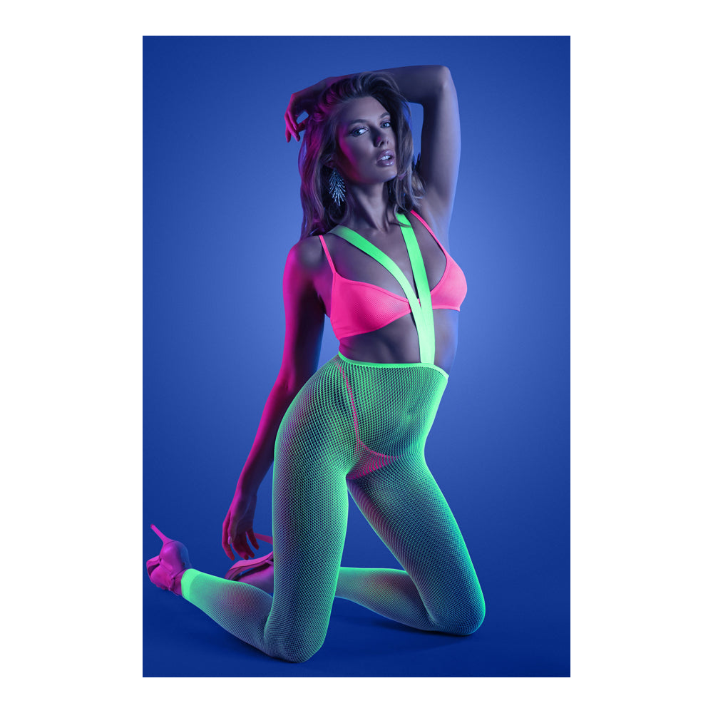 Model wearing the Glow Come Alive 3 Piece Suspender Stockings Set in neon pink and green under blacklight.