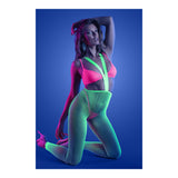 Model wearing the Glow Come Alive 3 Piece Suspender Stockings Set in neon pink and green under blacklight.