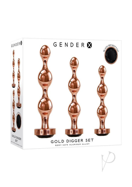 Gender X Gold Digger 3 Piece Anal Plug Set Rose Gold featuring sculptural metal plugs with black gem bottoms.