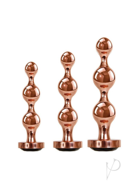 Gender X Gold Digger 3 Piece Anal Plug Set Rose Gold featuring sleek, sculptural metal plugs in rose gold finish.