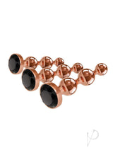 Gender X Gold Digger 3 Piece Anal Plug Set Rose Gold showcasing sleek metal plugs with black gems.