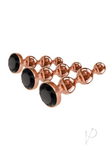 Gender X Gold Digger 3 Piece Anal Plug Set Rose Gold showcasing sleek metal plugs with black gems.