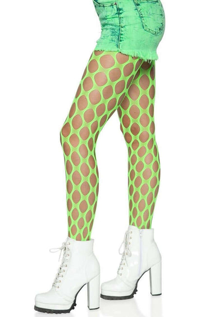 Leg Avenue Jumbo Pothole Net Tights OS Neon Green worn with a green outfit and white chunky boots.