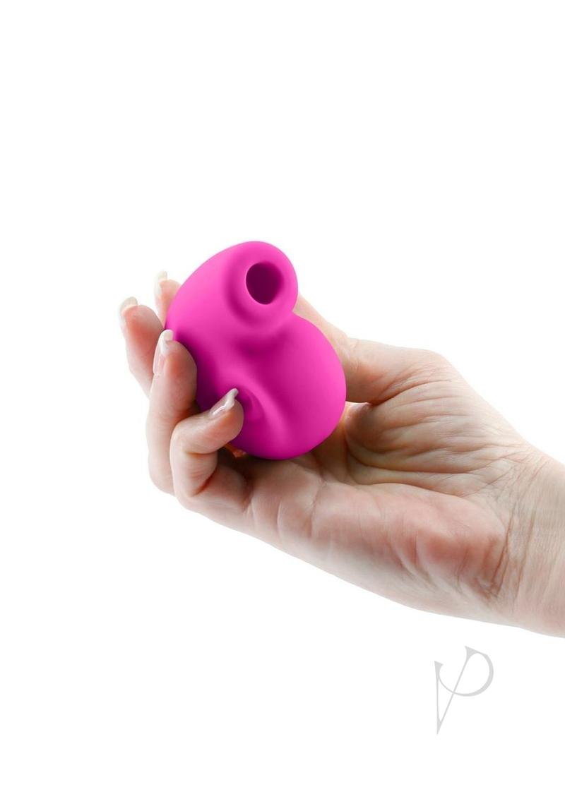 Revel Starlet Rechargeable Silicone Clitoral Stimulator Pink held in hand showcasing its plush silicone design.