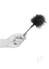 Ouch Feather Tickler Black Erotic Sensation Plume held in hand, perfect for teasing and sensation play.