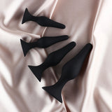 Edonista Alessandra 4 Piece Silicone Anal Plug Set Black displayed on soft satin fabric.