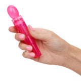Utopia Travel Massager Set Pink held in hand, highlighting its compact design and vibrant color.