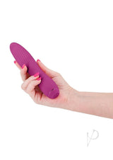 Obsessions Clyde Rechargeable Silicone Vibrator Magenta held in hand, showcasing its flexible design and vibrant color.