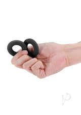 Person holding two Renegade Erectus Silicone Cock Rings in black for enhanced pleasure.