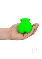 Ouch Ball Sack Glow in the Dark Green held in a hand, showcasing its vibrant fluorescent design.