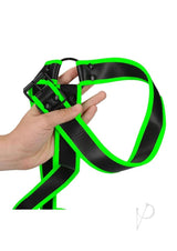 Ouch Gladiator Harness Glow in the Dark Large XLarge Green held by hand showcasing black and fluorescent green design.