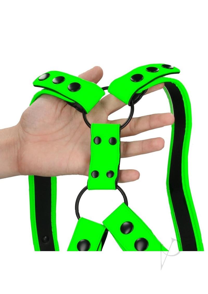 Ouch Sling Harness Glow in the Dark Small Medium Green held in hand, showcasing its vibrant design and detailing.
