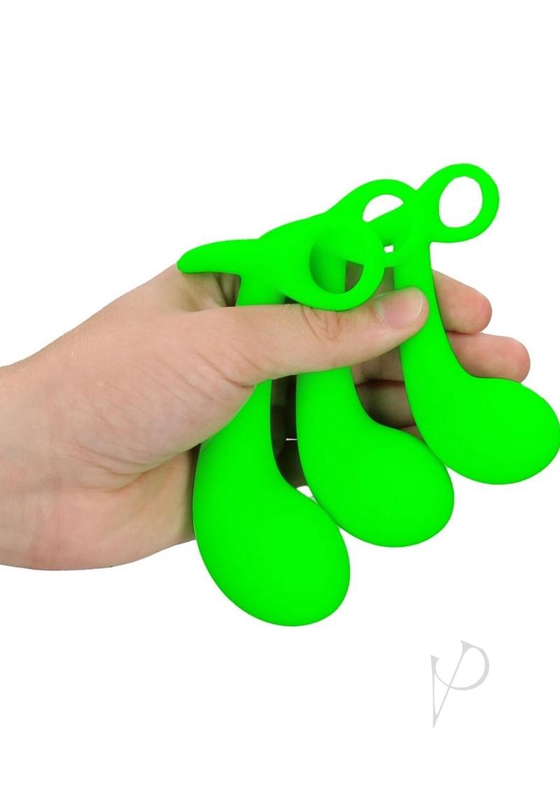 Ouch Prostate Kit Glow in the Dark 3 Pc Green held in a hand, featuring three glowing green silicone pieces.