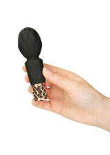 Pillow Talk Secrets Pleasure Rechargeable Wand Gold held in hand showcasing sleek design and elegant details.