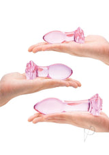 Glas Rosebud Butt Plug Set 3 Piece Pink displayed in open hands showing three graduated sizes.
