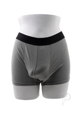 Gender X TPE Packer Dildo 4 inch Caramel displayed in gray packing shorts on a mannequin.