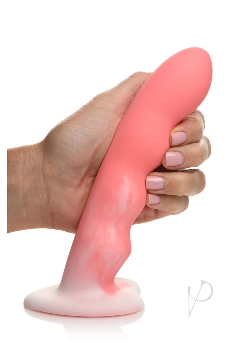 Simply Sweet Wavy Silicone Dildo Pink/White held in hand, showcasing its curves and design for pleasure.